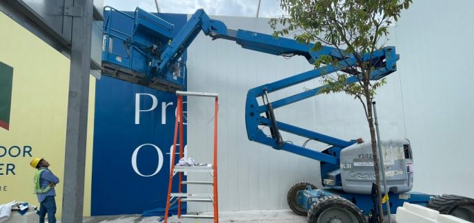 Labrador Tower construction hoarding with boomlift ongoing