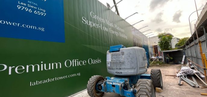 Labrador Tower construction hoarding with boomlift